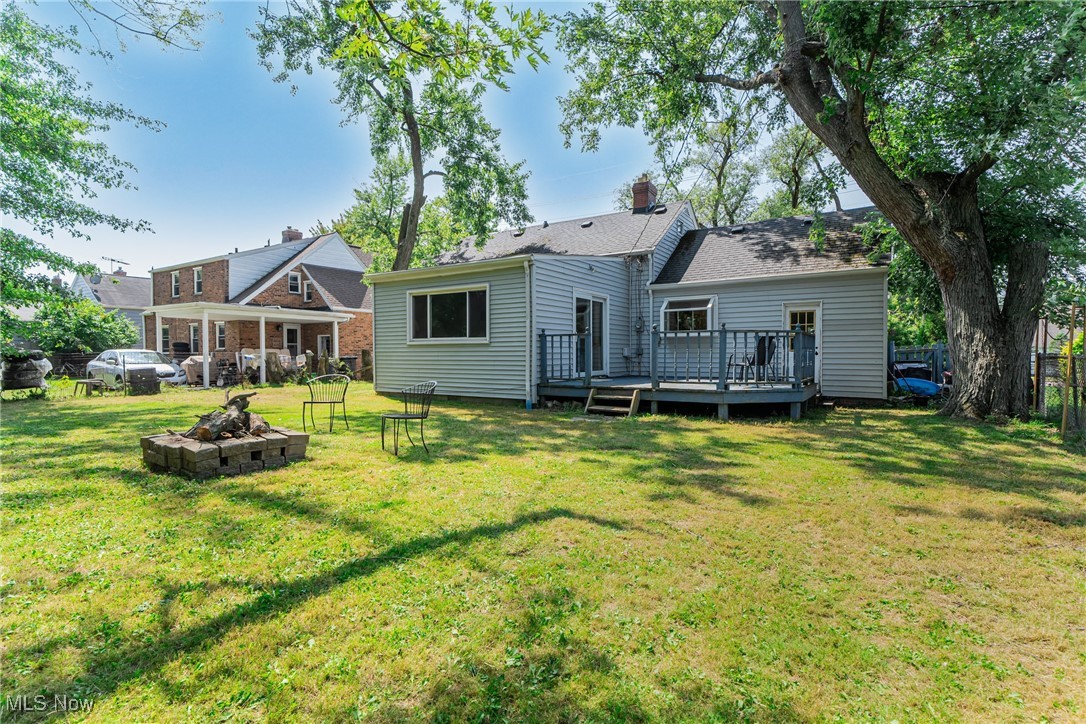 1607 Richmond Road Cleveland, OH 44124 - Photo 25 of 32 Rear view of house featuring a yard, an outdoor fire pit, and a wooden deck