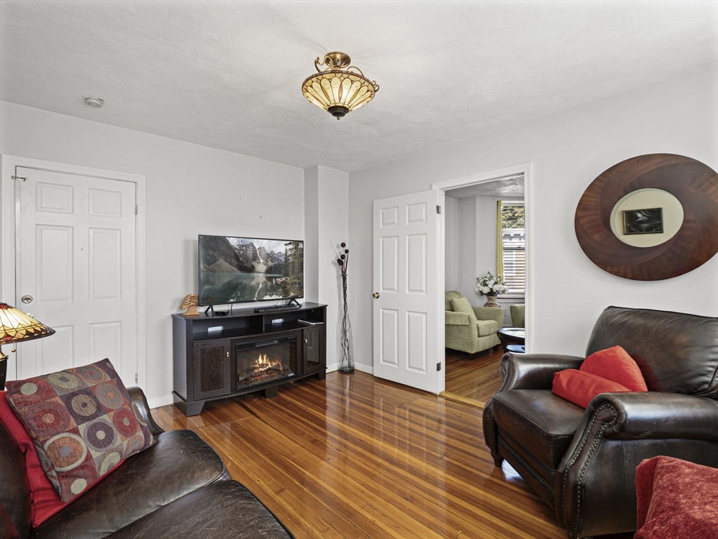95 Florida Street, Unit 2 Boston, MA 02124 - Photo 6 of 29 a living room with furniture and a flat screen tv