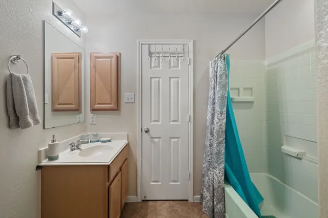 a bathroom with a sink a mirror and a shower