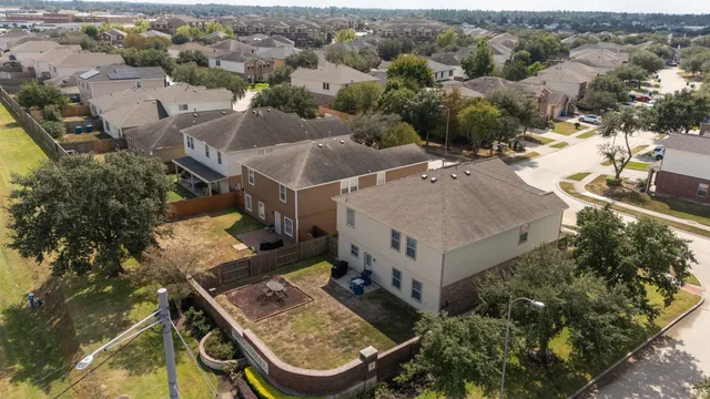 an aerial view of a house with swimming pool and mountains