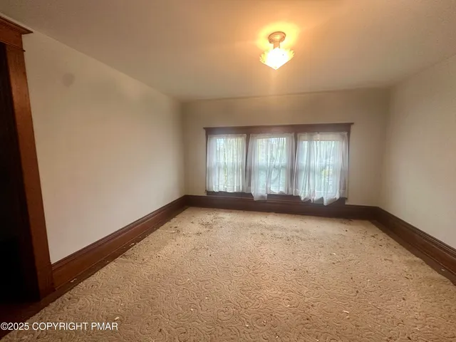 a view of a green yard with a small trees