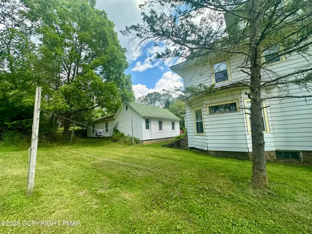 a view of a house with a backyard