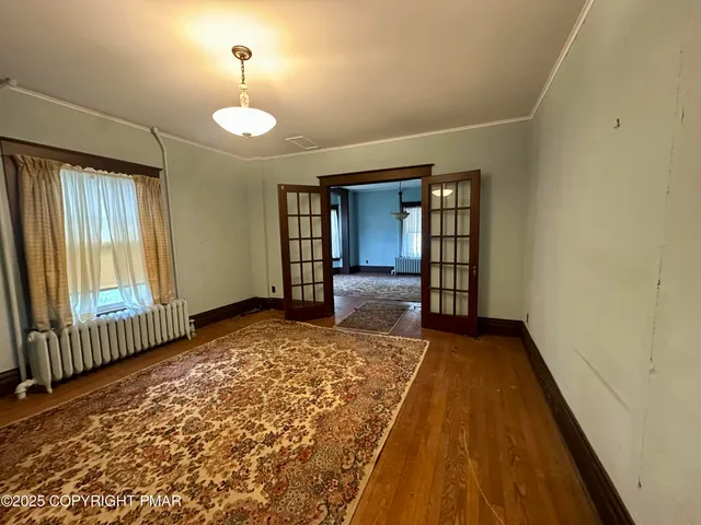 wooden floor in an empty room with a window