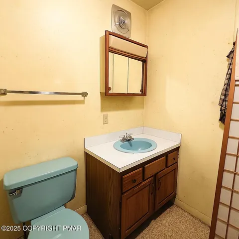 a bathroom with a toilet a sink and a mirror