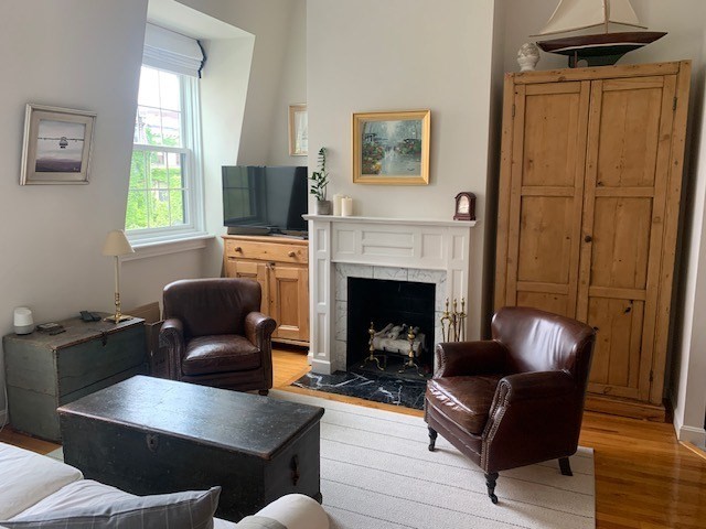 341 Beacon Street, Unit 5A Boston, MA 02116 - Photo 1 of 9 a living room with furniture and a fireplace
