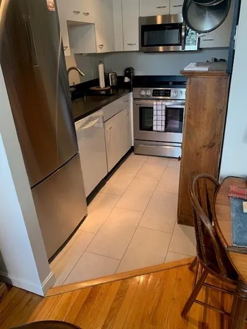 a kitchen with a sink a stove top oven and cabinetry