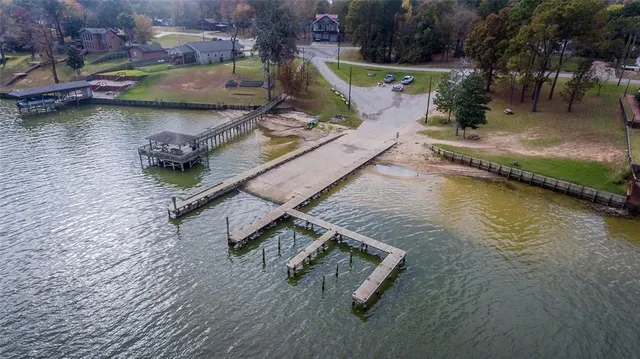 an aerial view of a house with swimming pool and a yard