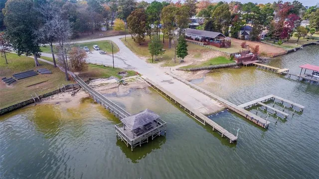 an aerial view of a house with a garden and lake view