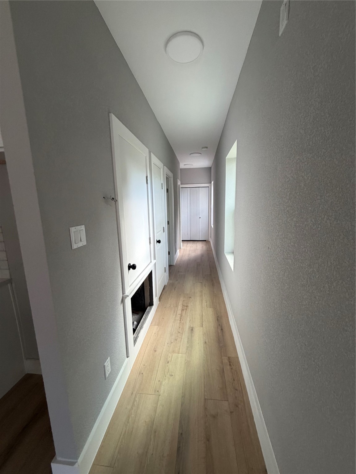 9914 Fillmore Street Houston, TX 77029 - Photo 10 of 11 a view of a hallway with wooden floor