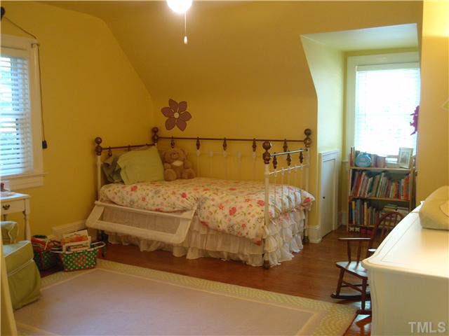 304 Brooks Avenue Raleigh, NC 27607 - Photo 12 of 14 a bed sitting in a bedroom next to a window