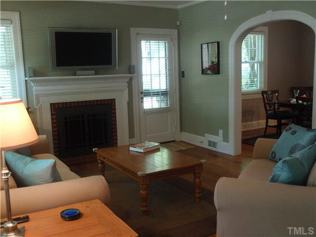 304 Brooks Avenue Raleigh, NC 27607 - Photo 4 of 14 a living room with furniture and a fireplace