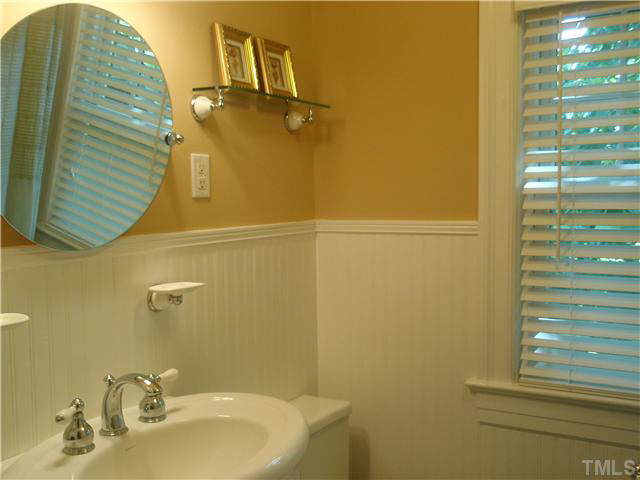 304 Brooks Avenue Raleigh, NC 27607 - Photo 10 of 14 a bathroom with a sink and a mirror