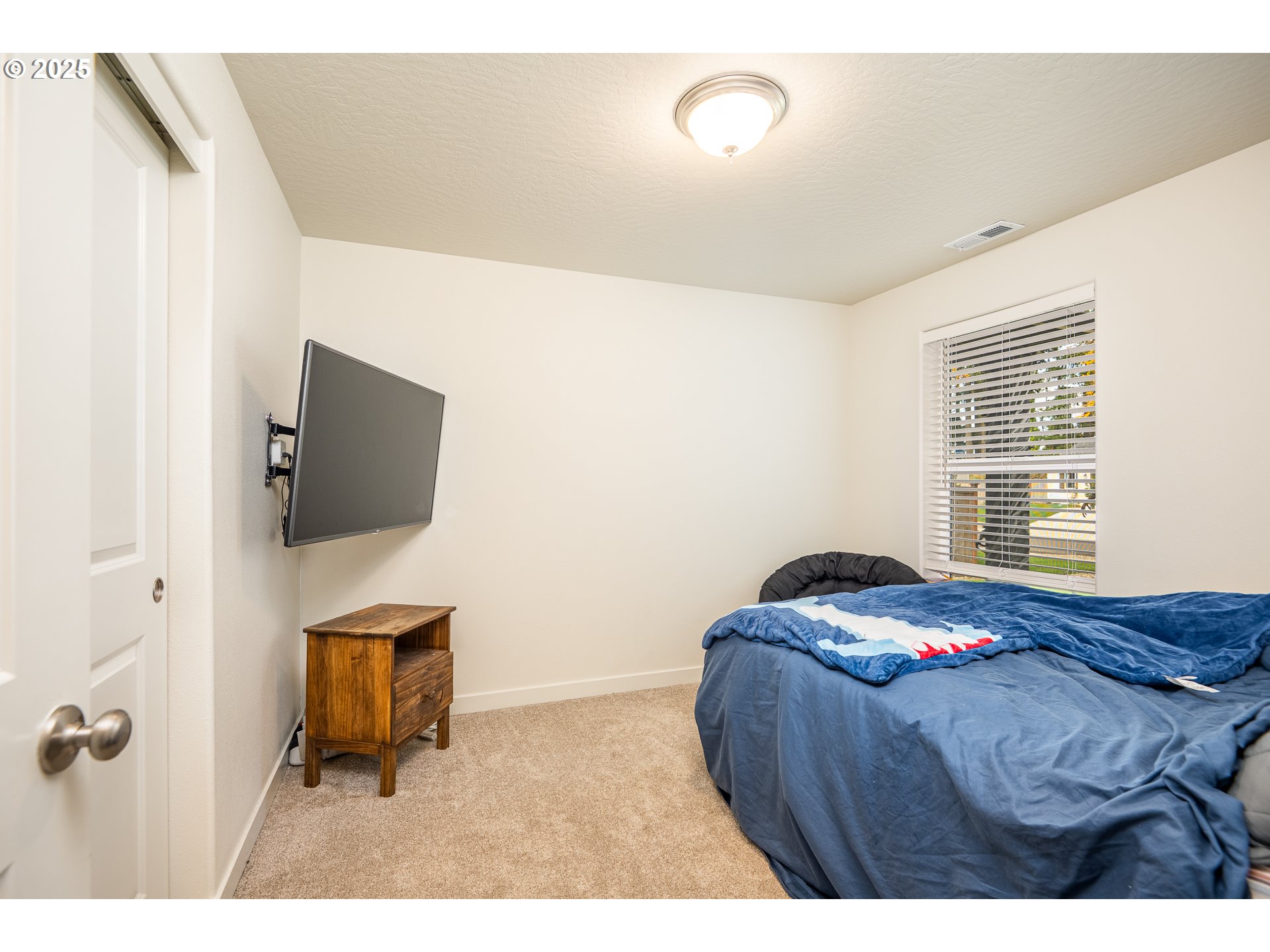 4967 Cedar View Drive Springfield, OR 97478 - Photo 13 of 22 a bedroom with a bed and flat screen tv