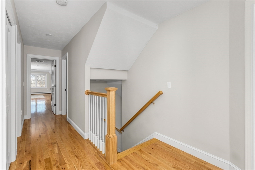 56 Fuller Place Franklin, MA 02038 - Photo 20 of 42 a view of a hallway with wooden floor and staircase