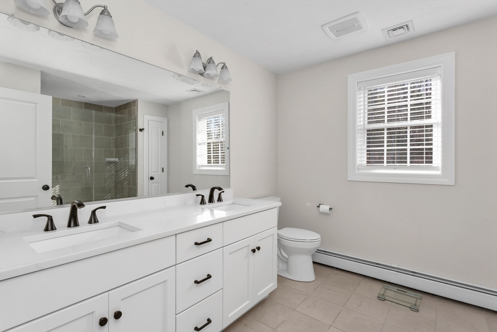 56 Fuller Place Franklin, MA 02038 - Photo 24 of 42 a bathroom with a double vanity sink toilet and a mirror