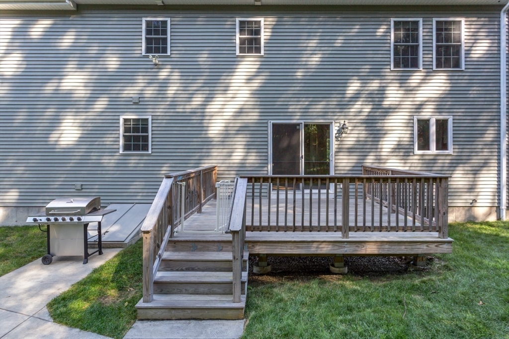 56 Fuller Place Franklin, MA 02038 - Photo 35 of 42 a view of a brick house with a wooden deck