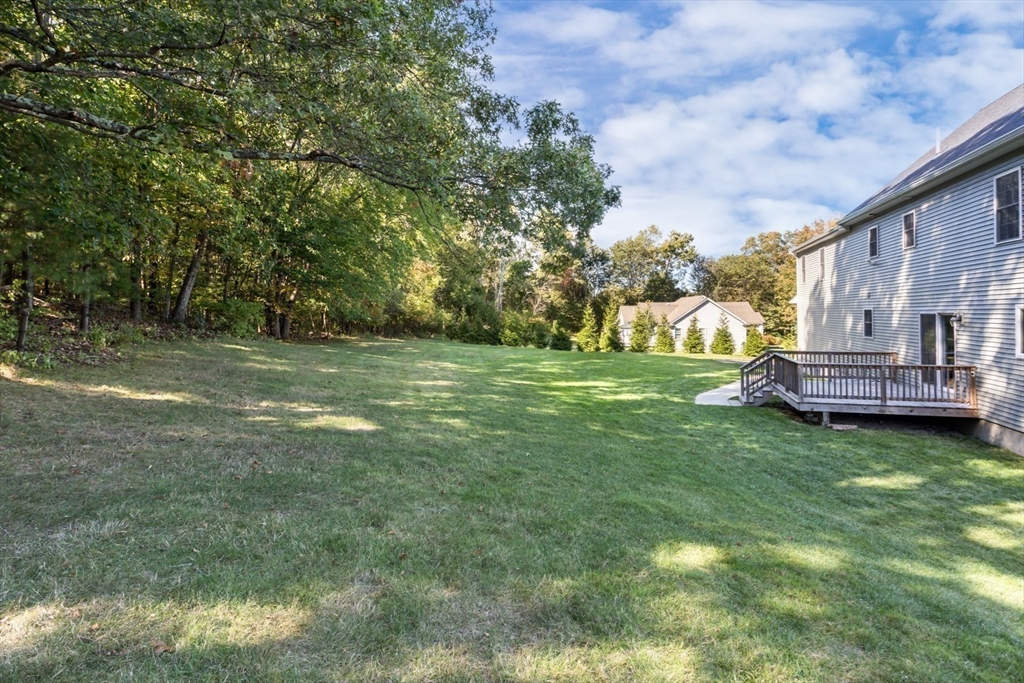 56 Fuller Place Franklin, MA 02038 - Photo 40 of 42 a backyard of a house with lots of green space