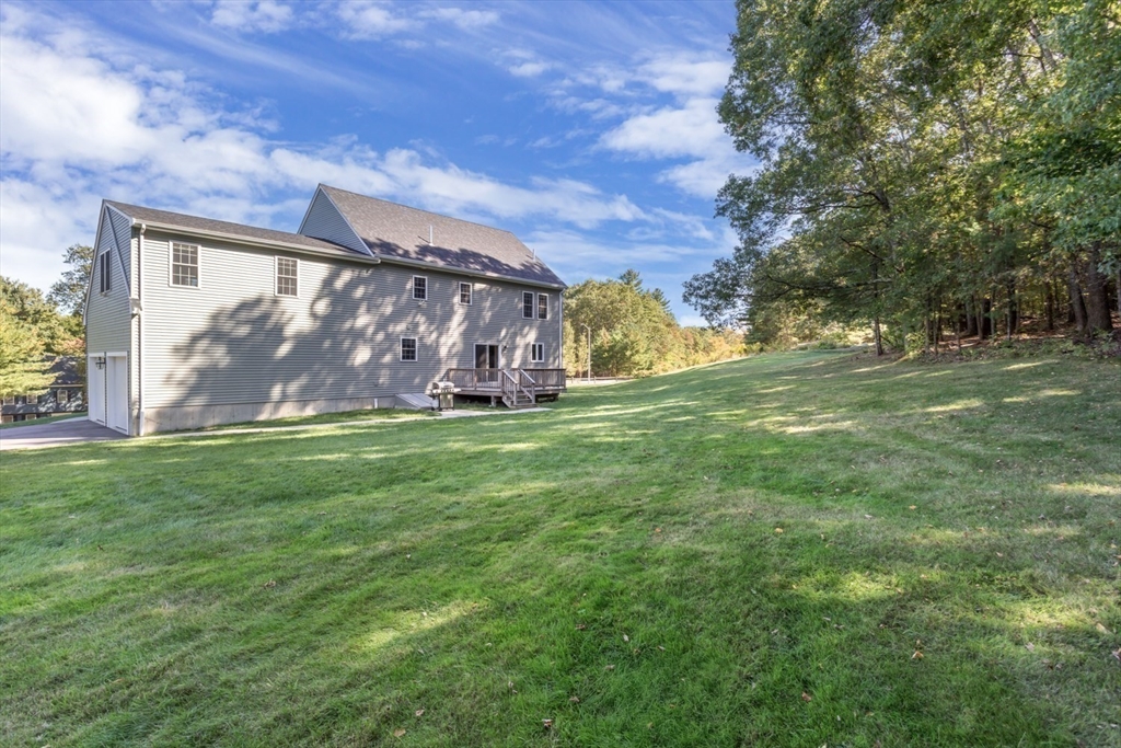 56 Fuller Place Franklin, MA 02038 - Photo 6 of 42 a view of a yard with an tree and wooden fence