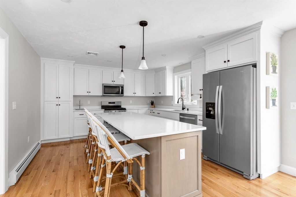 56 Fuller Place Franklin, MA 02038 - Photo 8 of 42 a kitchen with stainless steel appliances a refrigerator sink and microwave