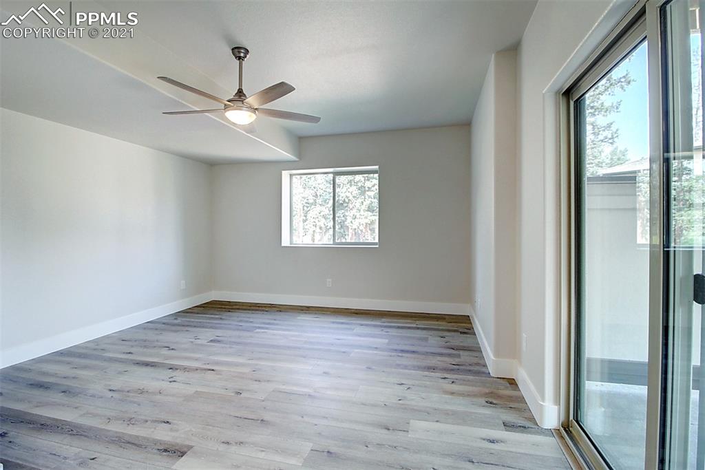 196 Shannon Place Divide, CO 80814 - Photo 17 of 25 a view of an empty room with wooden floor and a window