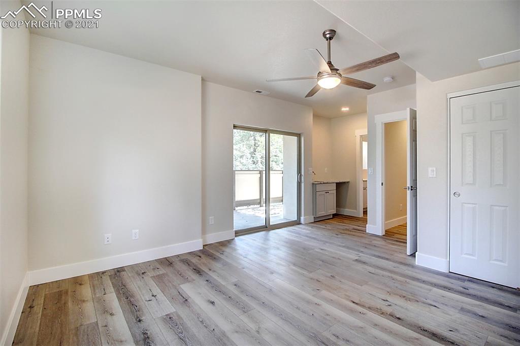 196 Shannon Place Divide, CO 80814 - Photo 18 of 25 an empty room with wooden floor and windows