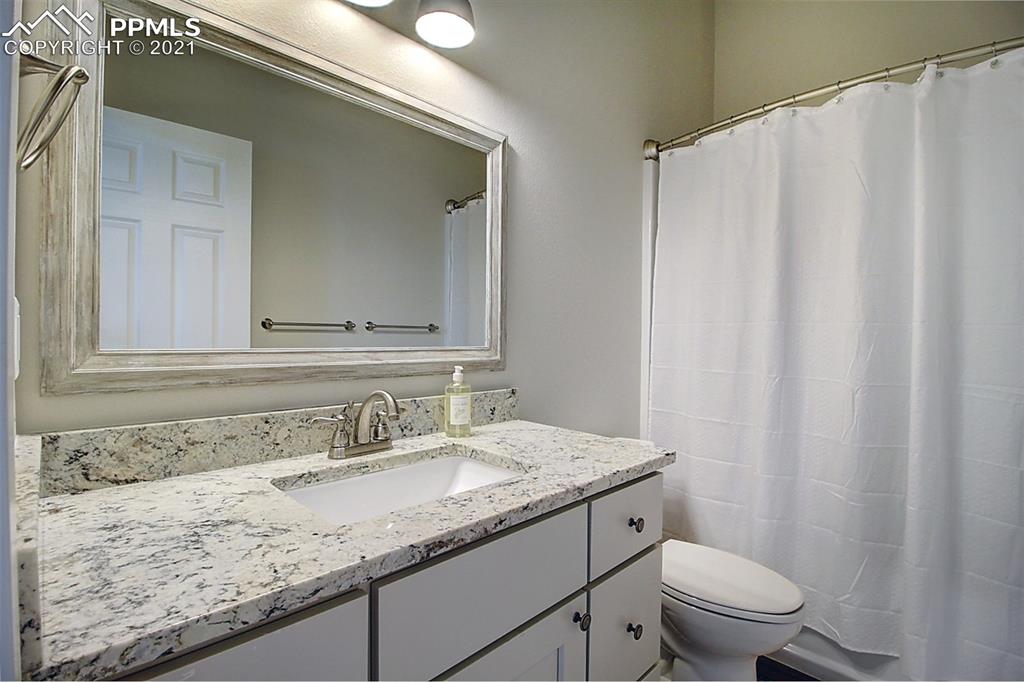 196 Shannon Place Divide, CO 80814 - Photo 20 of 25 a bathroom with a granite countertop sink and a mirror