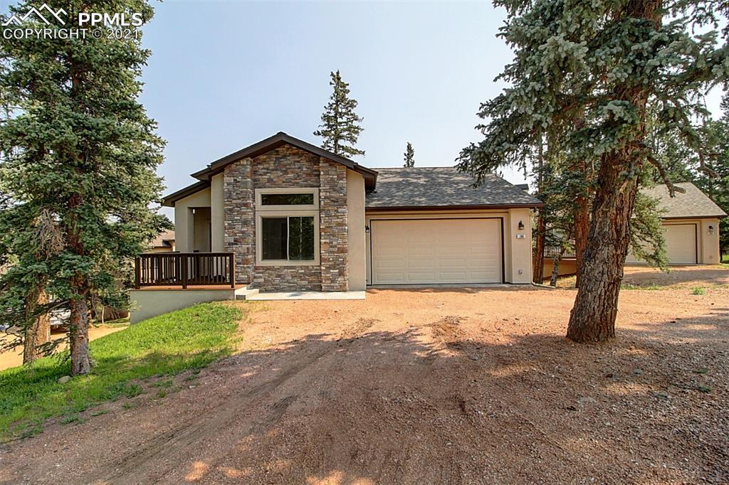 196 Shannon Place Divide, CO 80814 - Photo 3 of 25 a front view of a house with a yard and garage