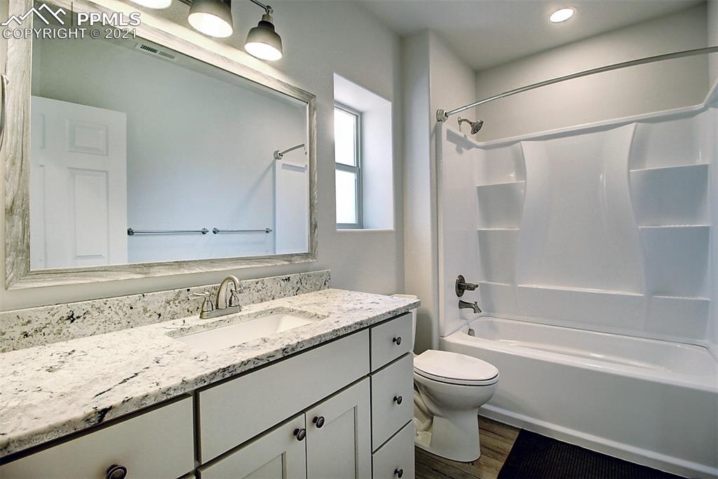 196 Shannon Place Divide, CO 80814 - Photo 21 of 25 a bathroom with a granite countertop sink toilet a shower and a mirror
