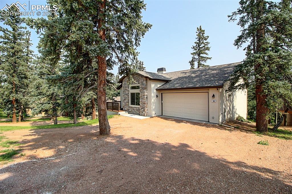 196 Shannon Place Divide, CO 80814 - Photo 4 of 25 a front view of a house with a yard and garage