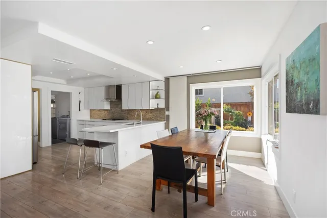 a dining room with furniture and a floor to ceiling window