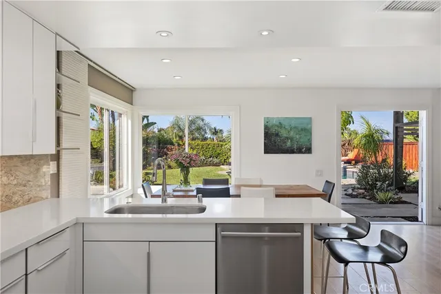 a kitchen with a sink and large window