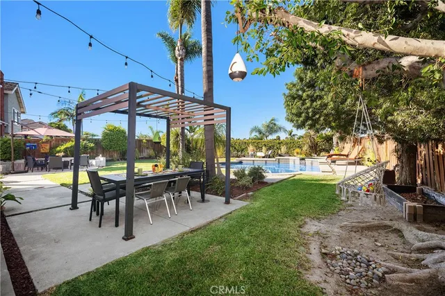 a view of a patio with table and chairs potted plants and palm tree