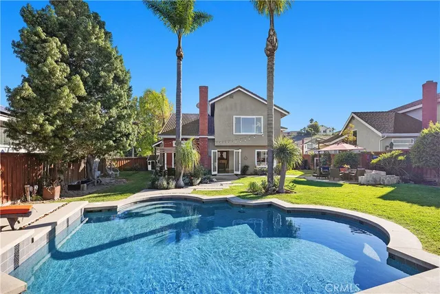 a swimming pool with outdoor seating and yard