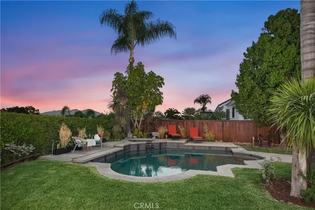a view of a swimming pool with a backyard