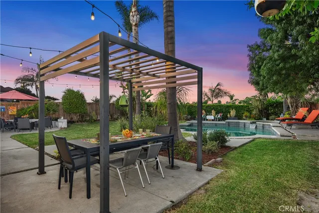 a view of a patio with a table chairs and a backyard