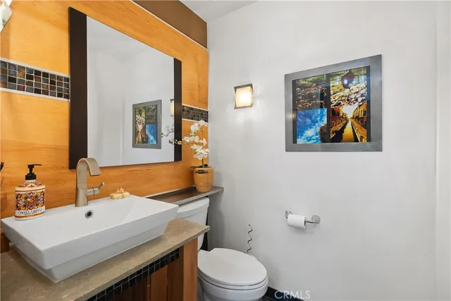 a bathroom with a toilet a sink and mirror