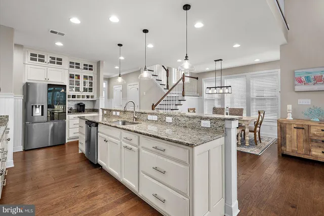 a kitchen with a table chairs and a chandelier