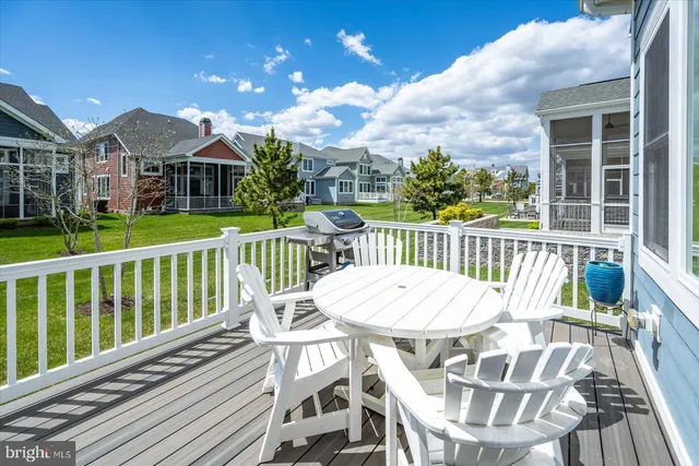 a front view of a house with glass windows and plants