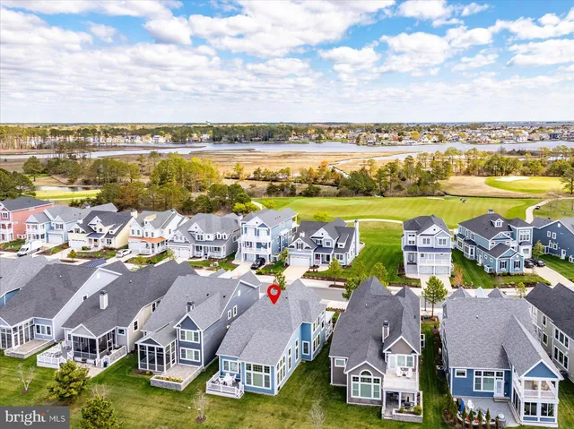 a front view of a house with a yard and potted plants