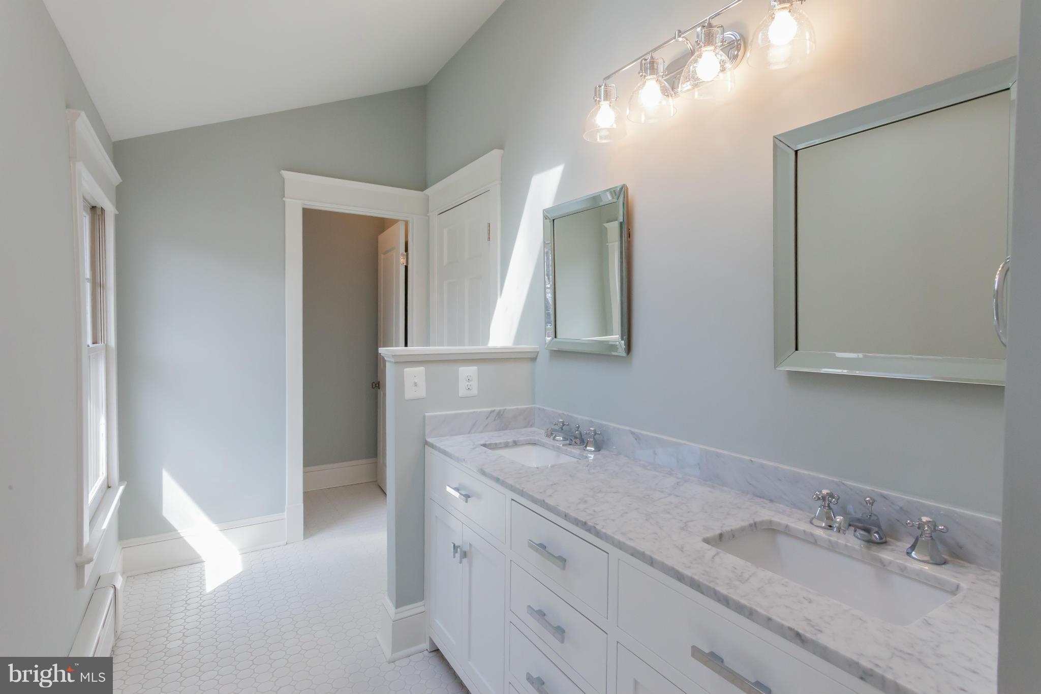 2531 Key Boulevard Arlington, VA 22201 - Photo 14 of 19 a bathroom with a granite countertop sink and a mirror