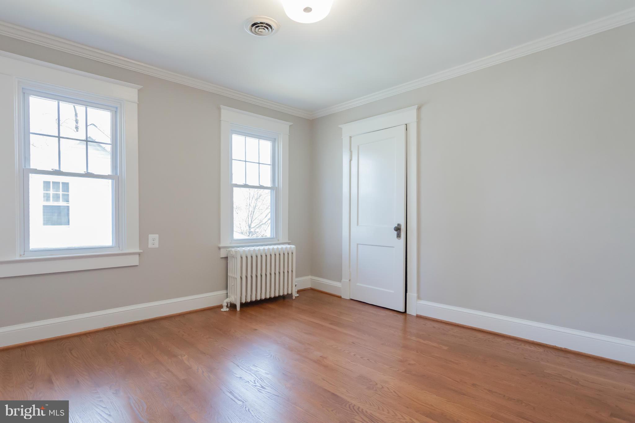 2531 Key Boulevard Arlington, VA 22201 - Photo 17 of 19 an empty room with wooden floor and windows