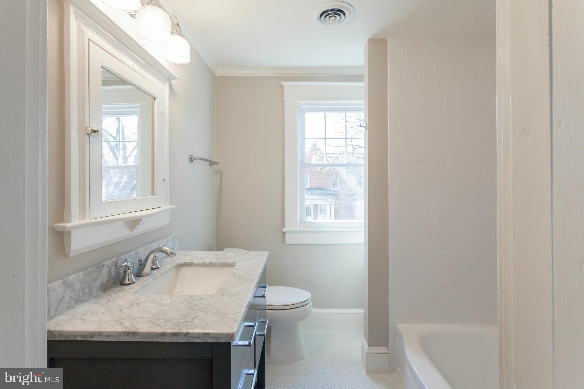 2531 Key Boulevard Arlington, VA 22201 - Photo 18 of 19 a bathroom with a granite countertop sink and a toilet