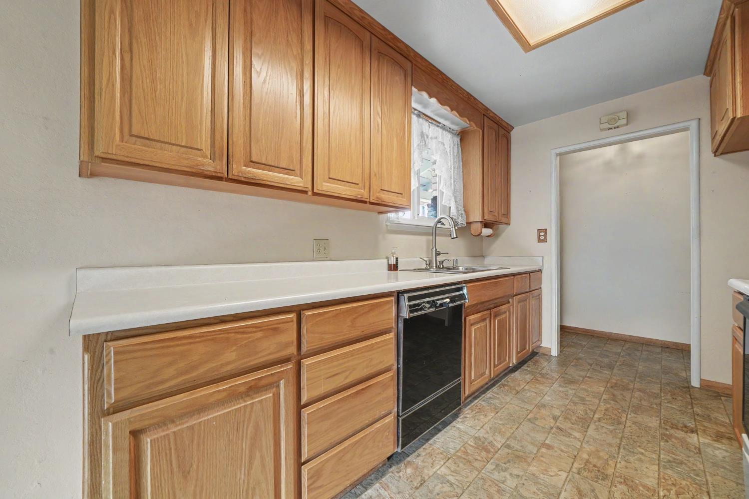 626 Sutter Lane Ione, CA 95640 - Photo 3 of 21 a kitchen with granite countertop cabinets stainless steel appliances and a sink