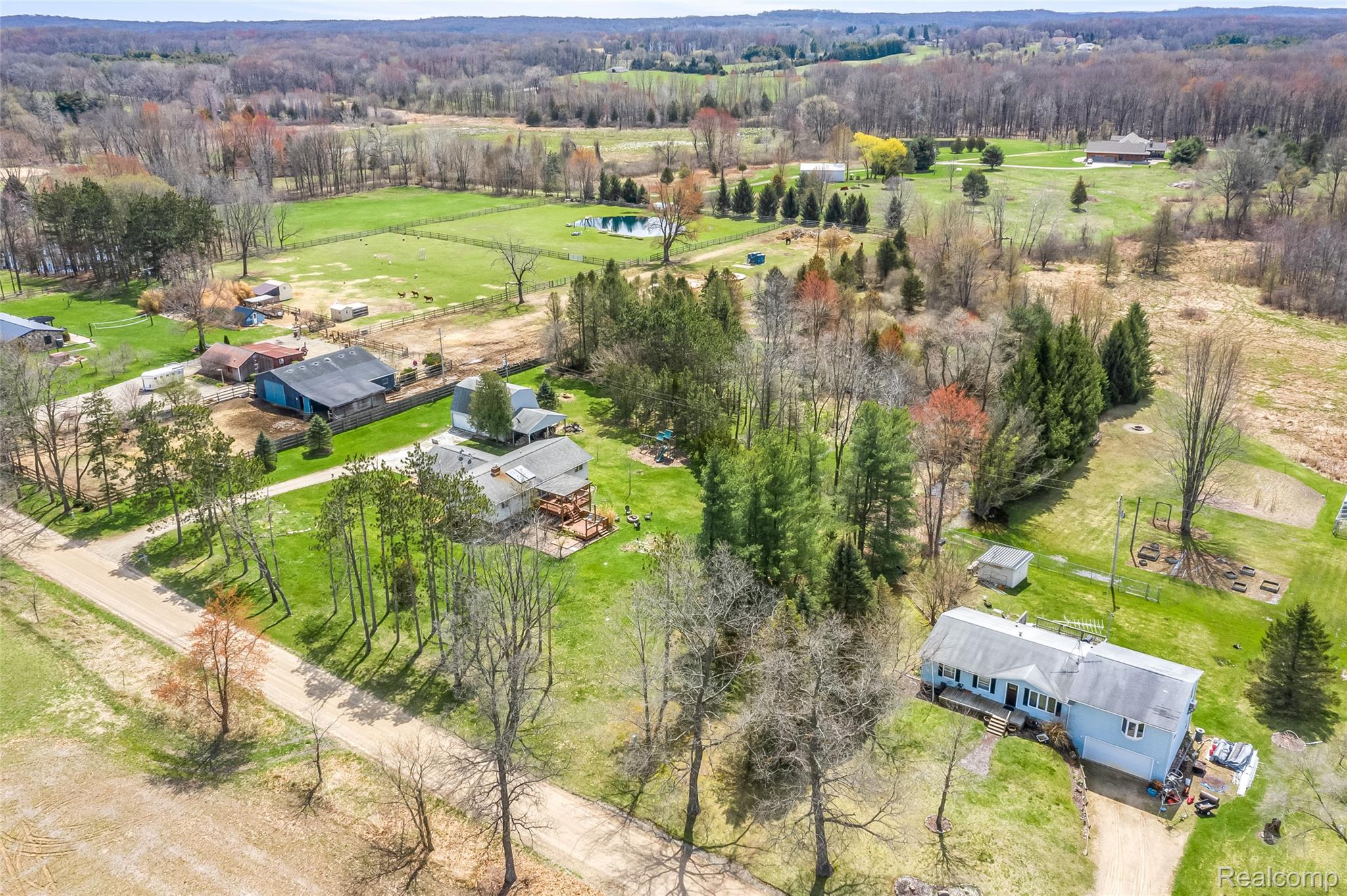 15395 Osius Road Chelsea, MI 48118 - Photo 50 of 55 Expansive rural property featuring a primary residence with an attached garage, a secondary residence, and multiple outbuildings