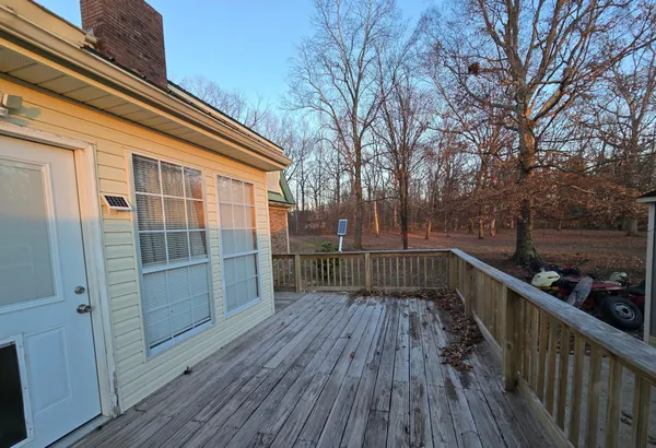 a view of deck with wooden floor and fence