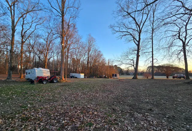 a view of a yard with a house in the background