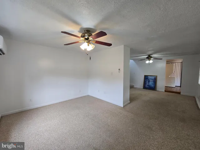 an empty room with a view of a house