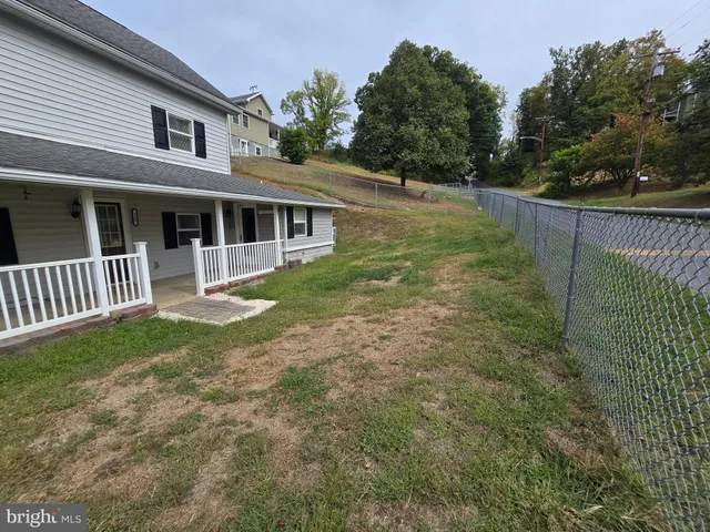 a view of a house with a yard and a garden