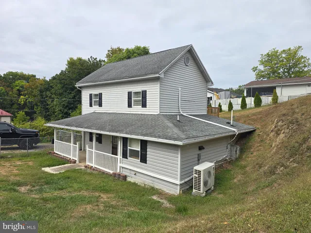 a aerial view of a house with a yard table and chairs