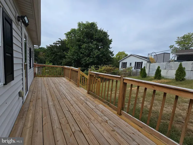 a view of balcony with wooden floor and fence